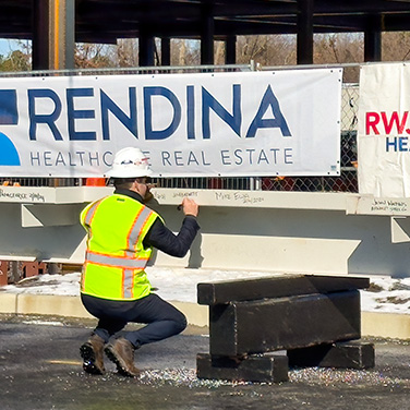 Construcion Worker With Rendina Logo Banner